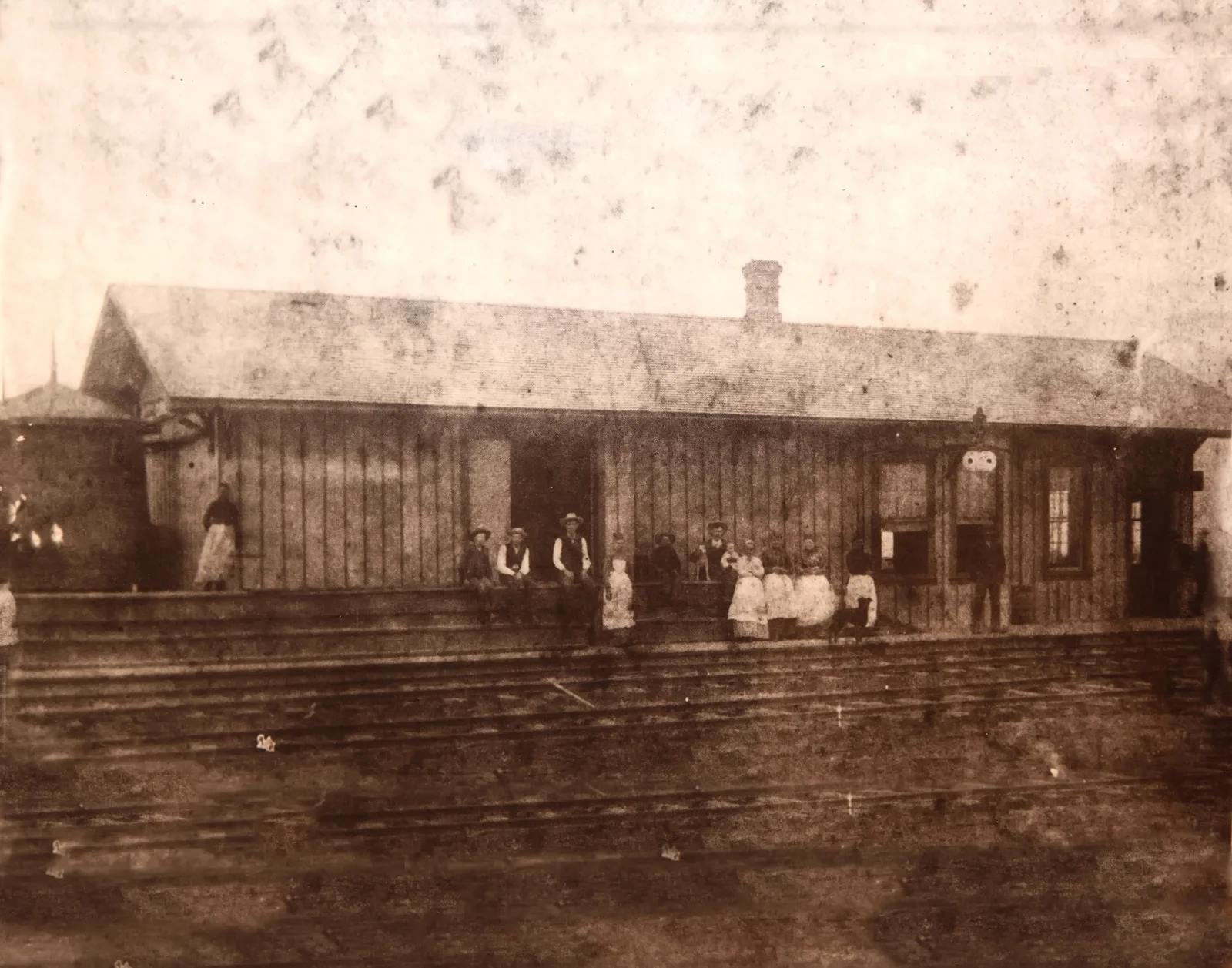 Historic wooden Cresson depot with townspeople beside the railroad tracks